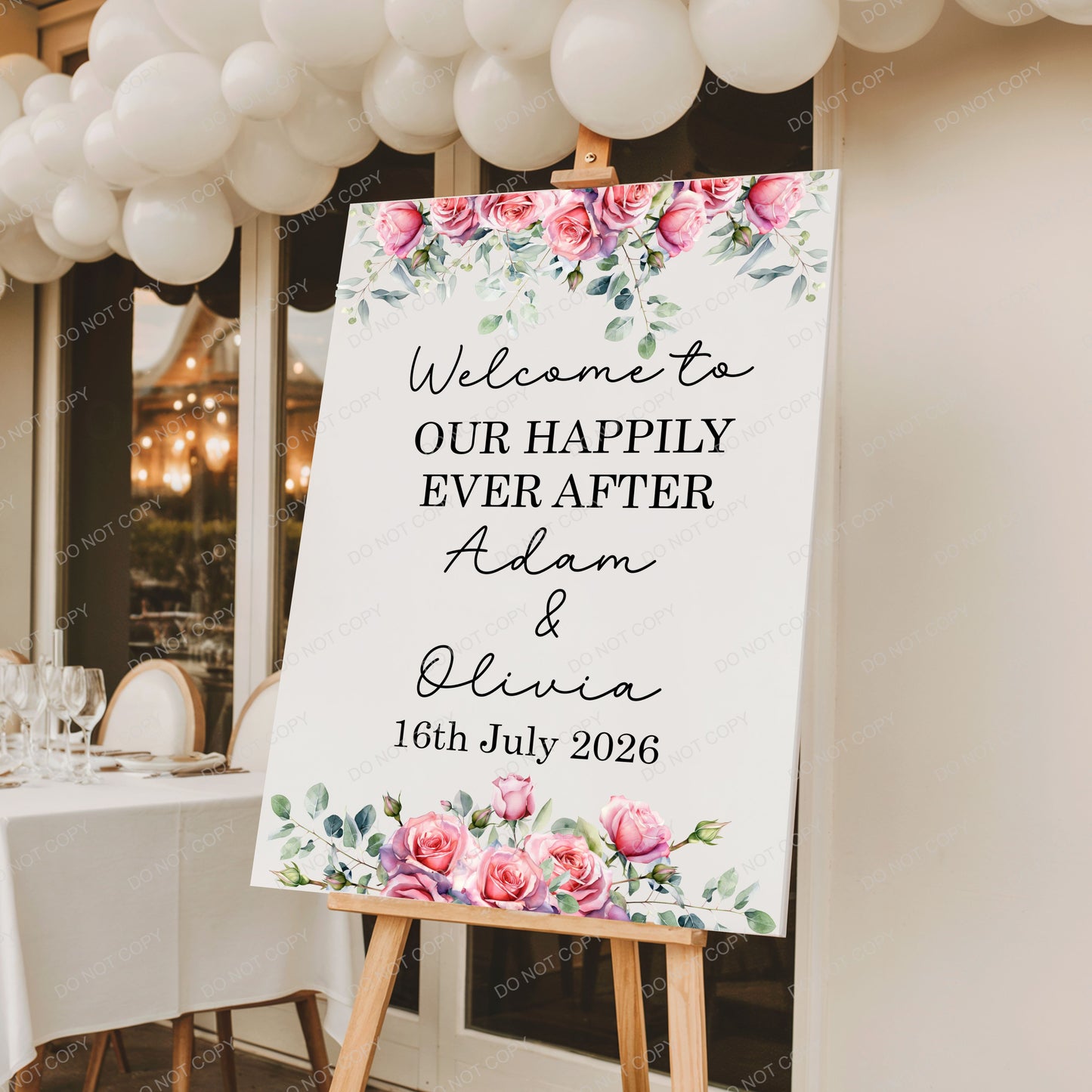 Wedding welcome sign with floral design and personalized text on an easel.