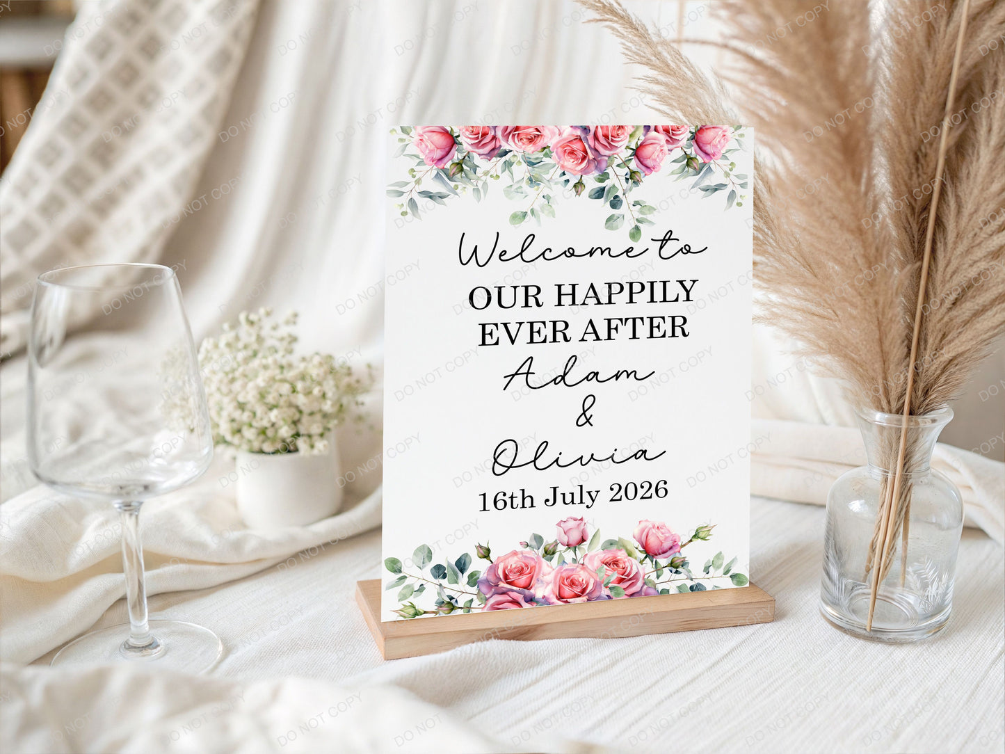 Decorative sign with floral design and wedding message on a table 