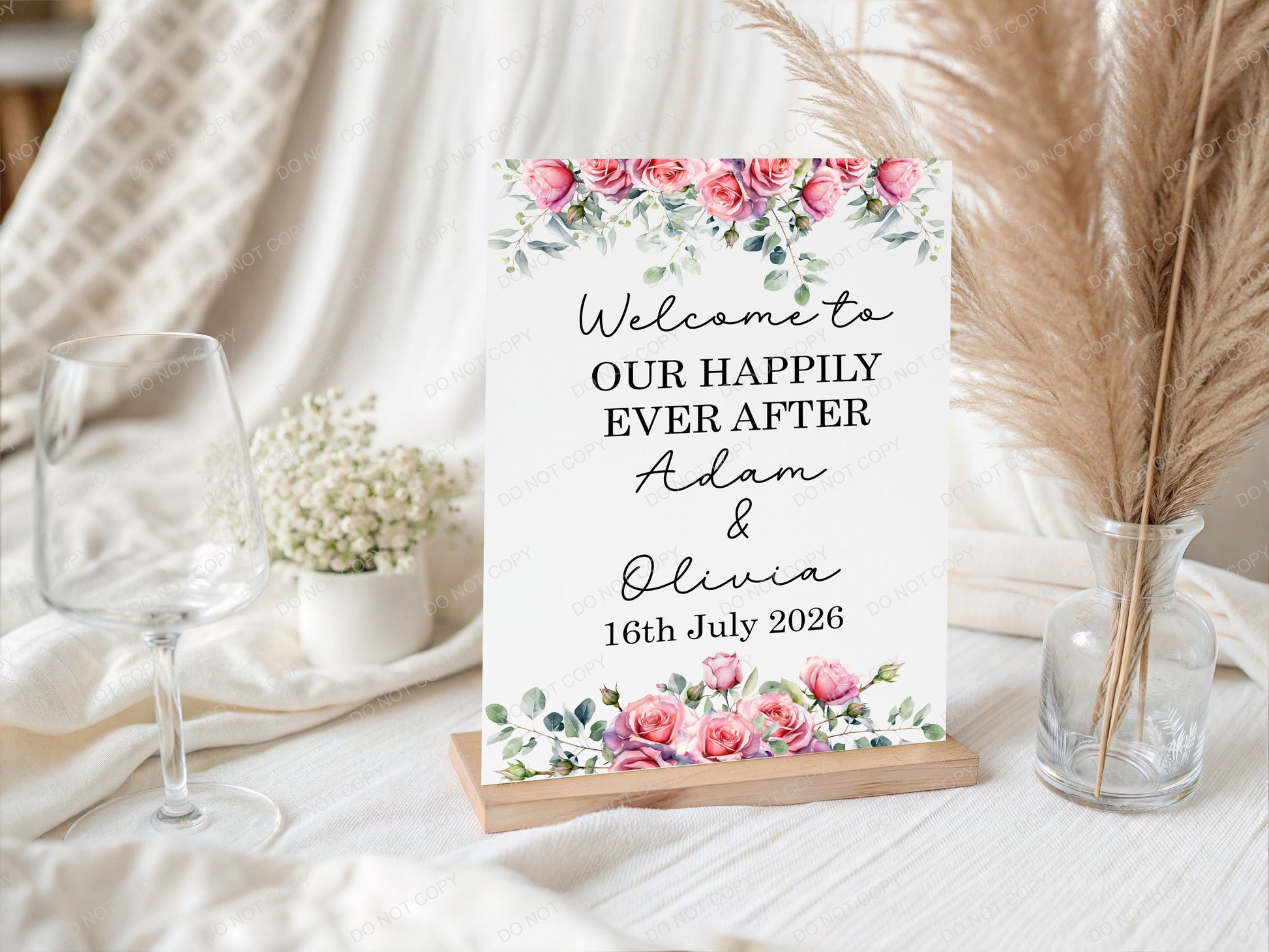 Decorative sign with floral design and wedding message on a table 